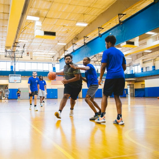 Students playing basketball in gym