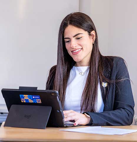 Smiling student using an Ipad