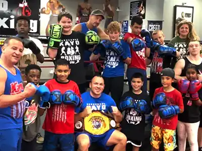 Students smiling with boxing instructors